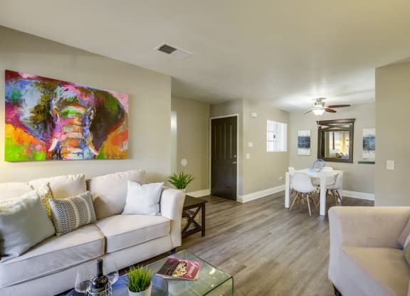Living Room with Stylish Decor, Hardwood Floor , Beige Walls and Cozy Fire Place at Vista Promenade Apartments, Temecula