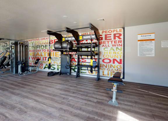 Fitness Center with All in One Training Station and Weight Machine at Aspire High Desert Apartments, Victorville, CA
