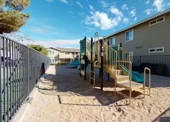 Playground with Jungle Gym in Sand Next to Apartment Buildings at Aspire High Desert Apartments, Victorville, California