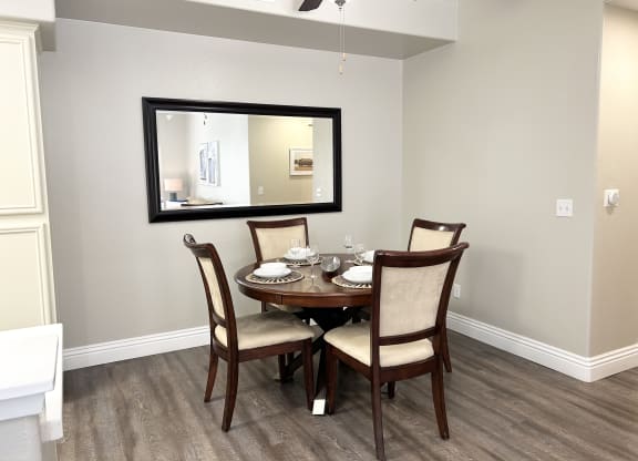 a dining room with a table and chairs at Riverton of the High Desert Apartments,Victorville, California