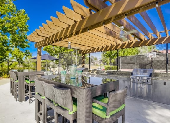 BBQ Area with Grills, Covered Patio, Modern Patio Furniture, and Ceiling Fan at Vista Promenade Apartments, Temecula