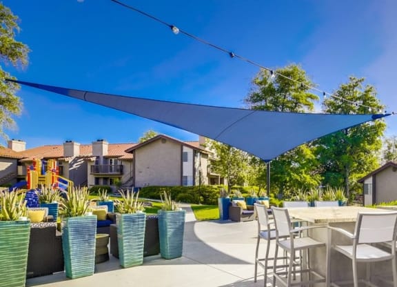 Exterior View of Vista Promenade Apartments Building Surrounded By Lush Landscaping with View of Outdoor Lounge at Vista Promenade Apartments, Temecula, CA