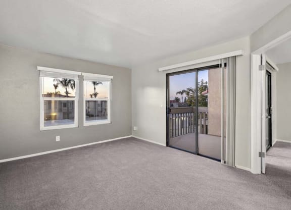 a bedroom with a sliding glass door and a balcony at Aspire Corona, Corona California