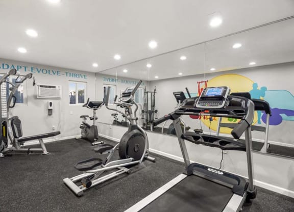 a gym with a treadmill and weights in it at Aspire Corona, Corona, CA 92882