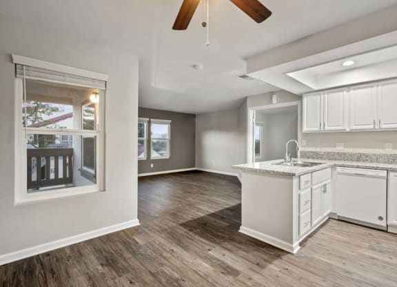 an empty kitchen and living room with a ceiling fan at Aspire Corona, Corona California