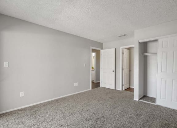 a bedroom with two doors and a carpeted floor at Aspire Redlands, Redlands, 92374