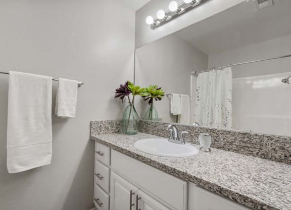 a bathroom with a sink and a mirror at Aspire Redlands, Redlands