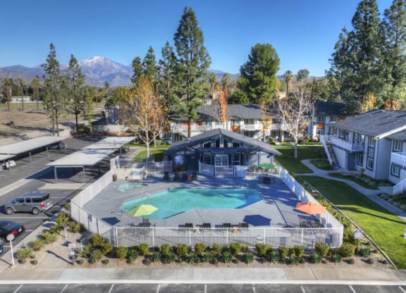 an aerial view of a resort style pool with a pool house in the background at Aspire Redlands, Redlands