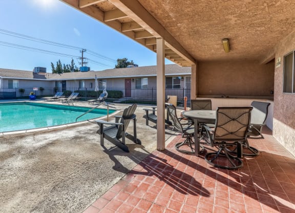 pool and a patio with chairs and tablesat Aspire Seneca, Victorville, 92392