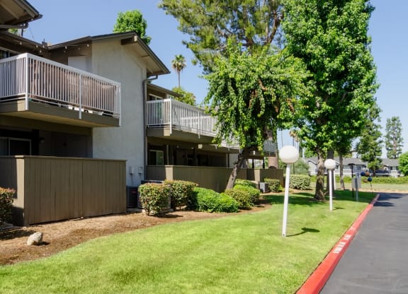 a building with a lawn and trees in front of it at Aspire Redlands, California, 92374