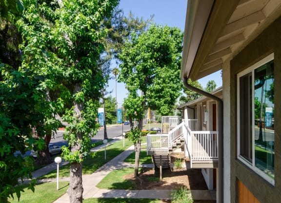 the front porch of a house with trees and a sidewalk at Aspire Redlands, Redlands, CA