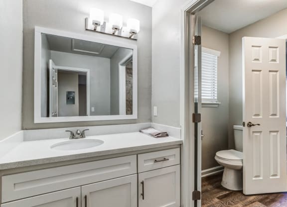 a bathroom with a sink and a mirror and a toiletat Aspire Seneca, Victorville