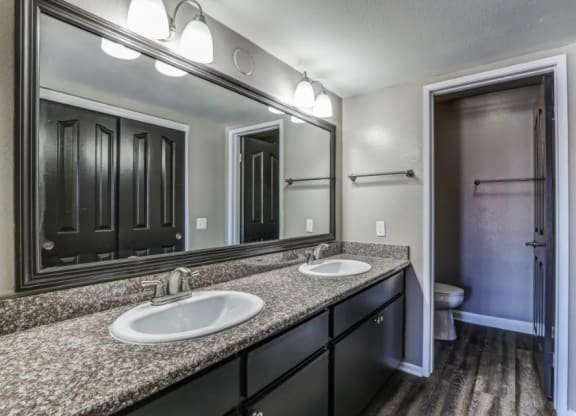 bathroom with granite countertops and side by side sink at Vista Promenade Apartments, Temecula