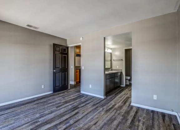 the living room and kitchen of a new home with wood flooring at Vista Promenade Apartments, California