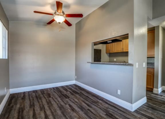 an empty living room with a ceiling fan at Vista Promenade Apartments, Temecula, California