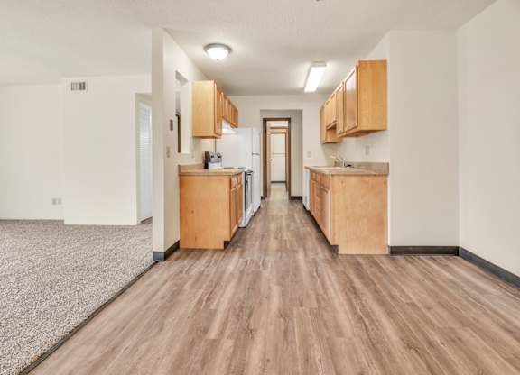 A long, narrow apartment with wood floors and cabinets. at Winding Hills Apartments, Iowa, 52807