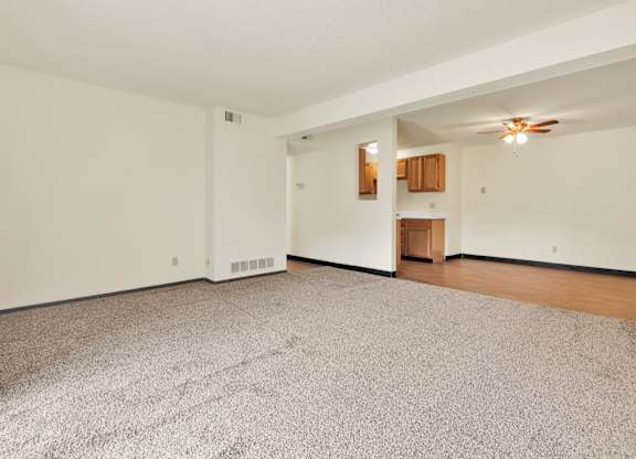 A room with a carpeted floor and a ceiling fan. at Winding Hills Apartments, Iowa