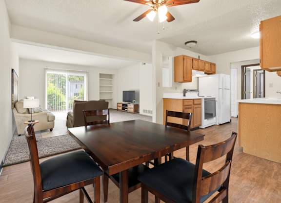 A dining room with a wooden table and chairs. at Winding Hills Apartments, Iowa