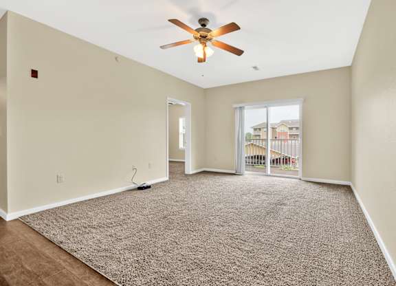 Carpeted Living Area With Ceiling Fan at Deer Valley Apartments, Illinois, 61282
