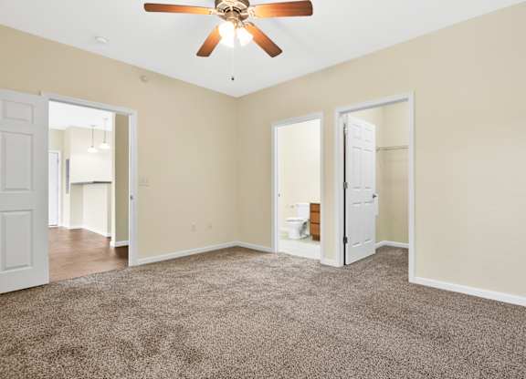 A room with a ceiling fan and carpeted floor. at Deer Valley Apartments, Illinois