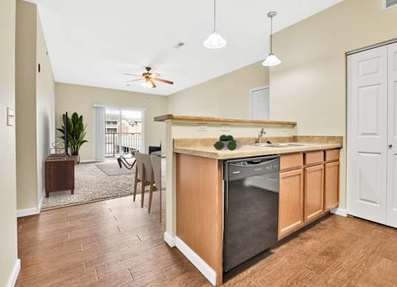 A kitchen with a wooden counter and a black dishwasher. at Deer Valley Apartments, Silvis