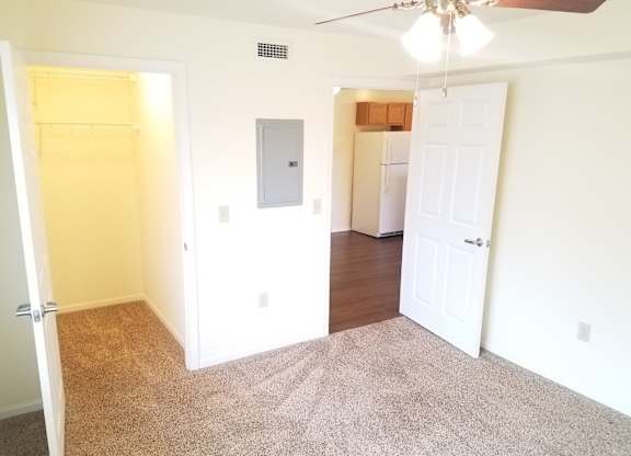 A room with a ceiling fan and a door.at Windsor Crest Apartments, Davenport , Iowa