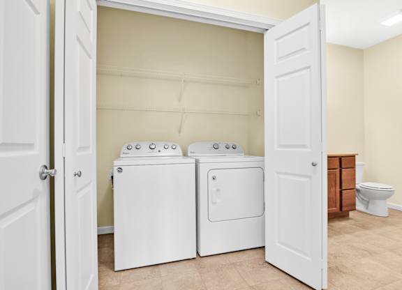 A laundry room with a washer and dryer in it. at Deer Valley Apartments, Silvis, 61282