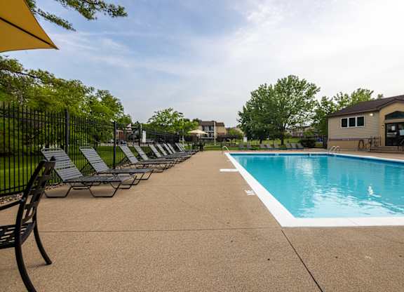 Pool With Relaxing Chairs at Indian Ridge Apartments, Davenport, Iowa