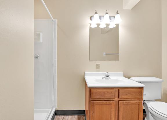 A bathroom with a white sink and toilet. at Kimberly Club Apartments, Davenport, 52807