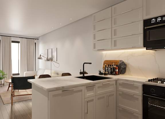 A modern kitchen with a black countertop and white cabinets at The Woods at 180 Kanata Avenue, Kanata