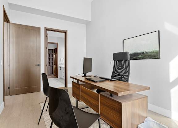 A room with a desk and a chair.