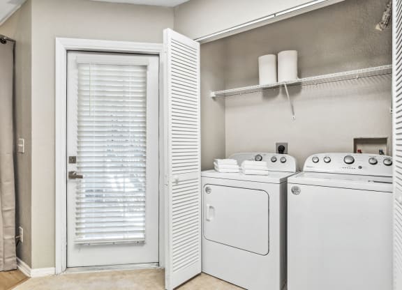 a washer and dryer in a laundry room with a door to a closet at Reserve at Temple Terrace, Temple Terrace, FL 33637