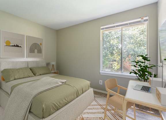 A bedroom with a bed, desk, and chair.