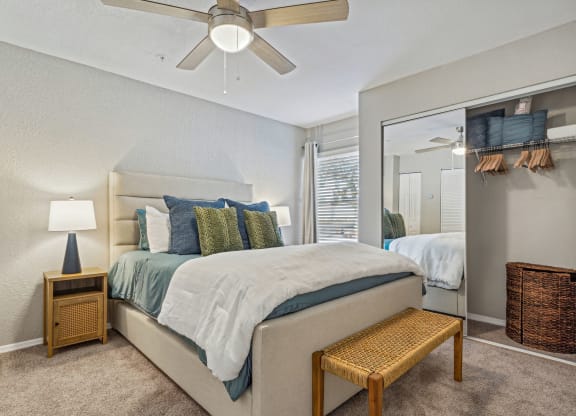 a bedroom with a large mirror and a ceiling fan at Reserve at Temple Terrace, Temple Terrace, FL 33637