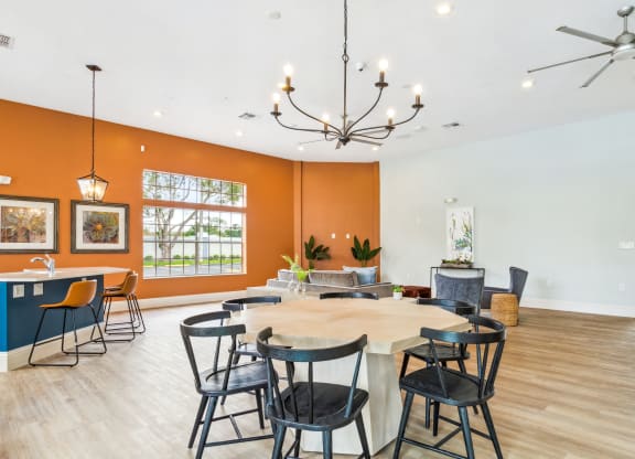 a club room with a large table and chairs at Reserve at Temple Terrace, Temple Terrace