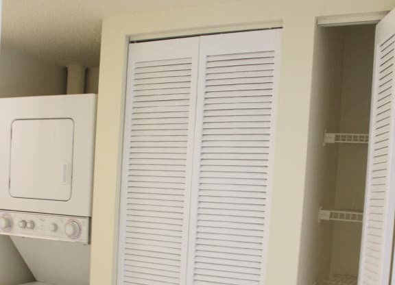 a closet with white shutters in a laundry room at Sunscape Apartment Homes, Tampa, FL