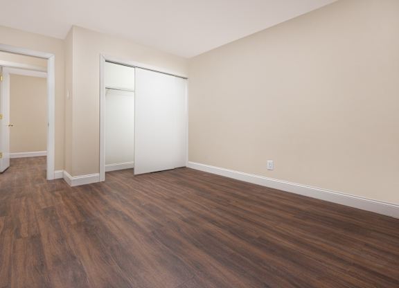 A room with wooden floors and white walls.