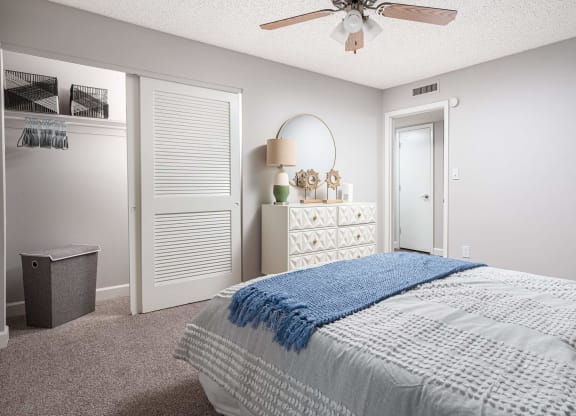 a bedroom with a bed and a ceiling fan  at The Park at Chesterfield Apartment Homes, Tampa