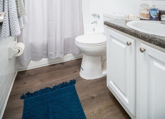a white bathroom with a shower and a toilet  at The Park at Chesterfield Apartment Homes, Tampa
