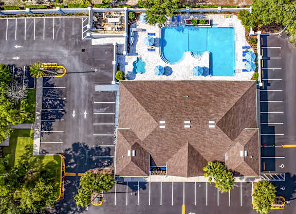 A large building with a pool in front of it.