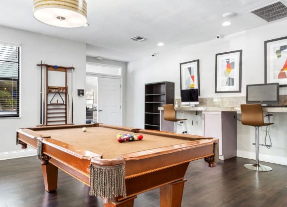 a pool table in a living room with a bar and a television at Waterford Park Apartment Homes, LLC, Lauderhill, 33319
