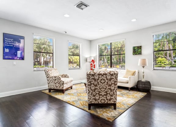 a living room with a couch and two chairs and windows at Waterford Park Apartment Homes, LLC, Lauderhill Florida