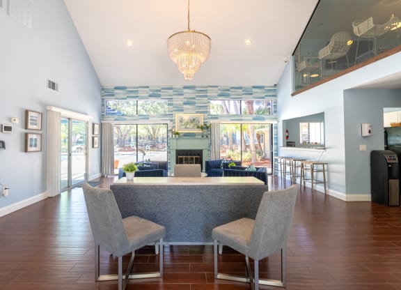 a dining room and living room with a table and chairs  at Fisherman's Landing Apartment Homes, Florida, 33637