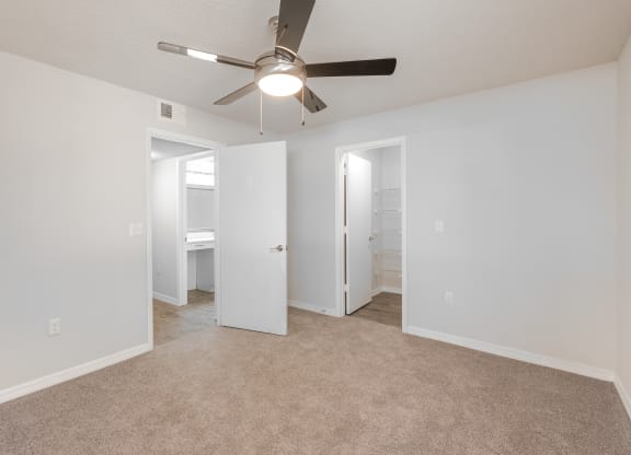 an empty living room with a ceiling fan and a closet  at Fisherman's Landing Apartment Homes, Tampa, 33637