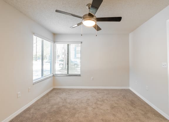 an empty living room with a ceiling fan and a window  at Fisherman's Landing Apartment Homes, Tampa, 33637