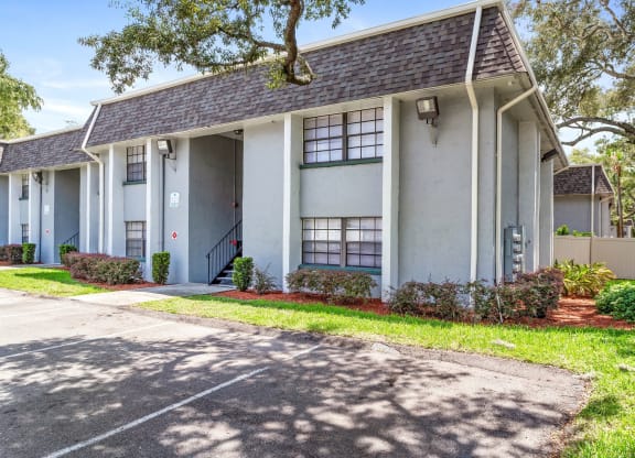a white house with a sidewalk in front of it at Greenwich Commons Apartment Homes, Florida, 33613