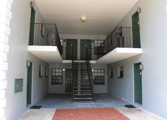 the inside of a building with stairs and a balcony at Greenwich Commons Apartment Homes, Tampa
