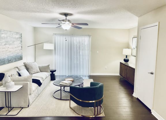 a living room with a couch and a ceiling fan at Madison Oaks Apartment Homes, LLC, Palm Harbor