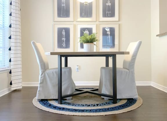 a dining room with a table and chairs and a rug at Madison Oaks Apartment Homes, LLC, Florida, 34684