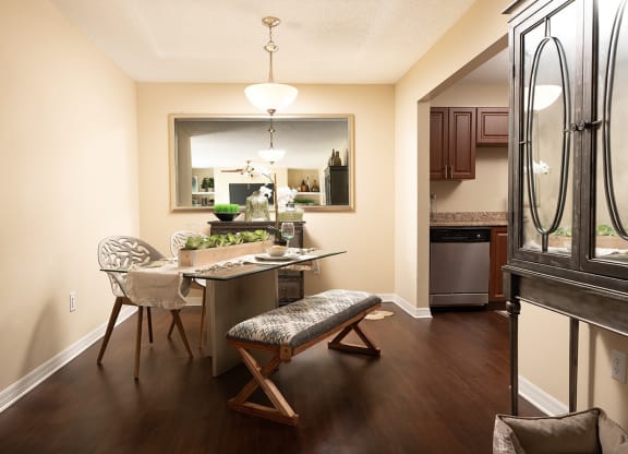 a dining room and kitchen with a table and chairs at Madison Oaks Apartment Homes, LLC, Palm Harbor, FL 34684